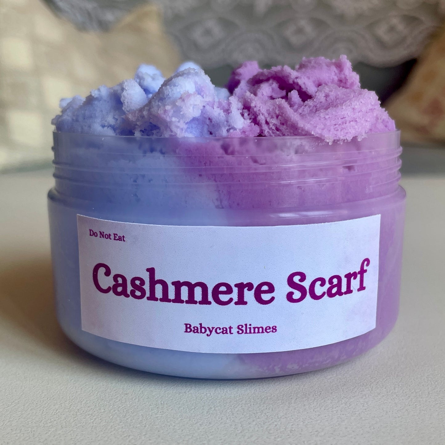 A jar is filled with two-tone purple cloud slime. The label reads "Cashmere Scarf Babycat Slimes"
