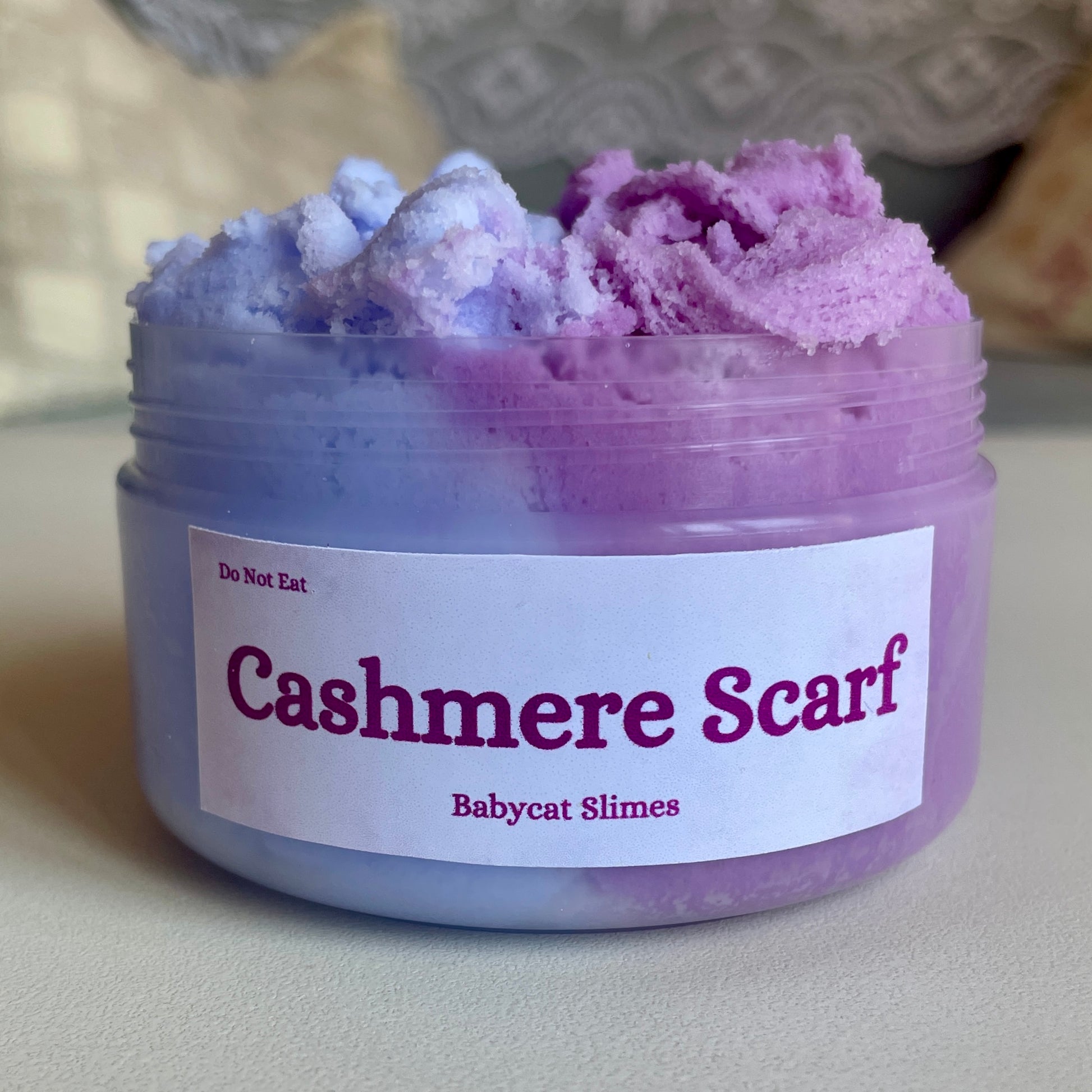 A jar is filled with two-tone purple cloud slime. The label reads "Cashmere Scarf Babycat Slimes"