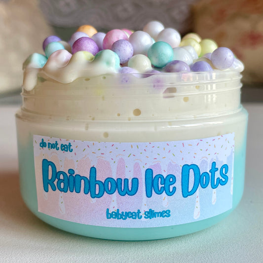 Jar is filled with blue and white slay slime filled with pastel rainbow foam balls. Label reads "Rainbow Ice Dots, Babycat Slimes"